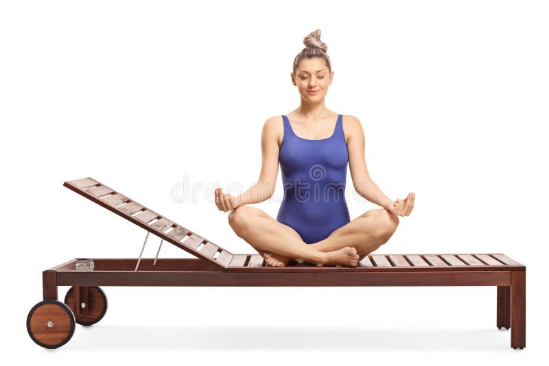 Young woman sitting on a lounge chair practicing meditation stock images Young woman sitting on a lounge chair practicing meditation stock images