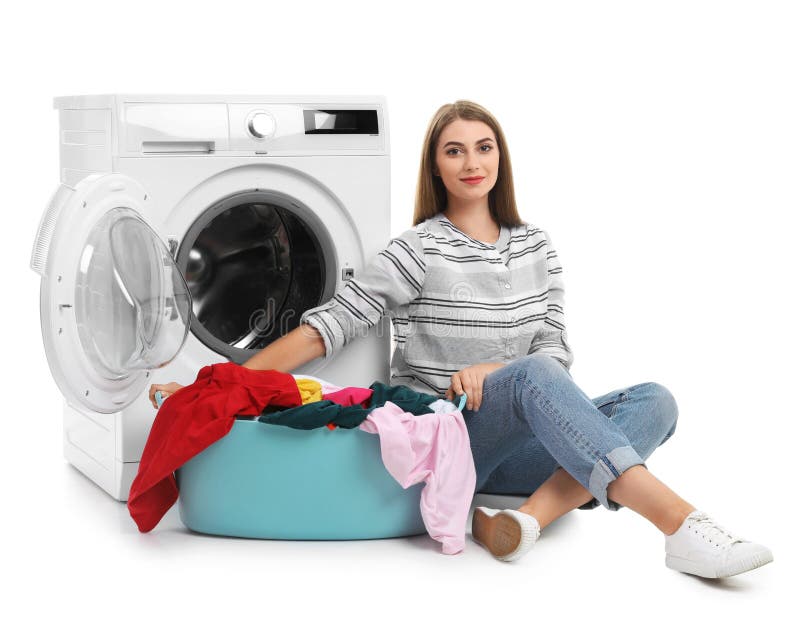 Young woman sitting near washing machine. 