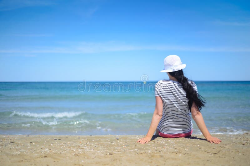 Young Woman Sitting on Sand and Looking To a Sea Stock Photo - Image of ...