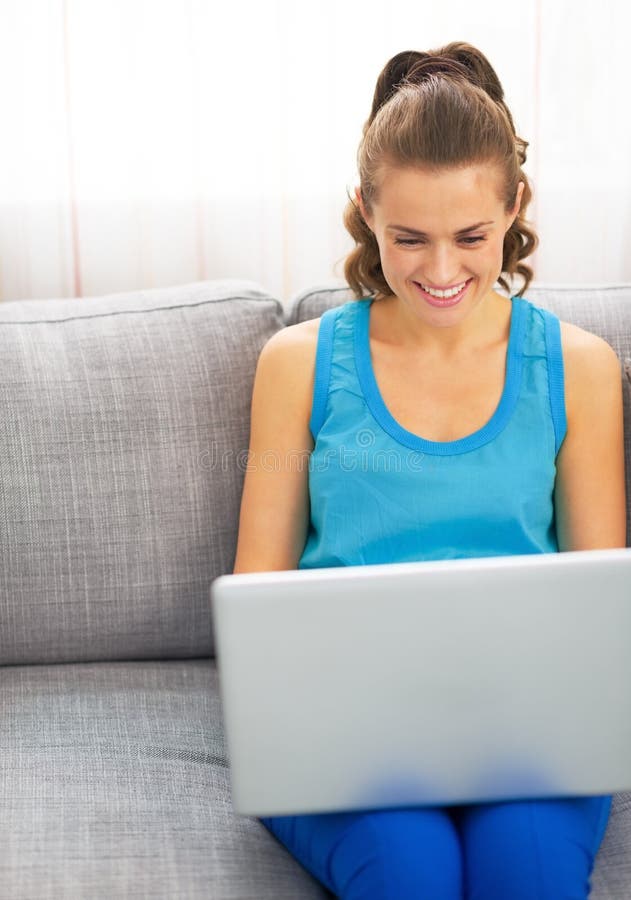 Young Woman Sitting on Sofa and Using Laptop Stock Image - Image of ...