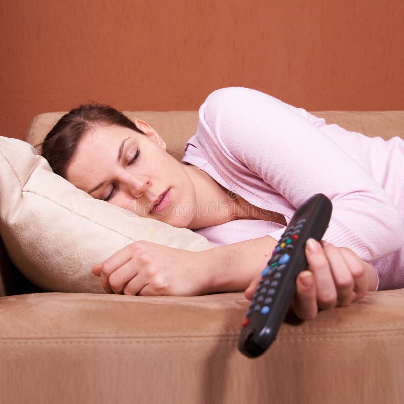 Young woman sleeping in front of TV