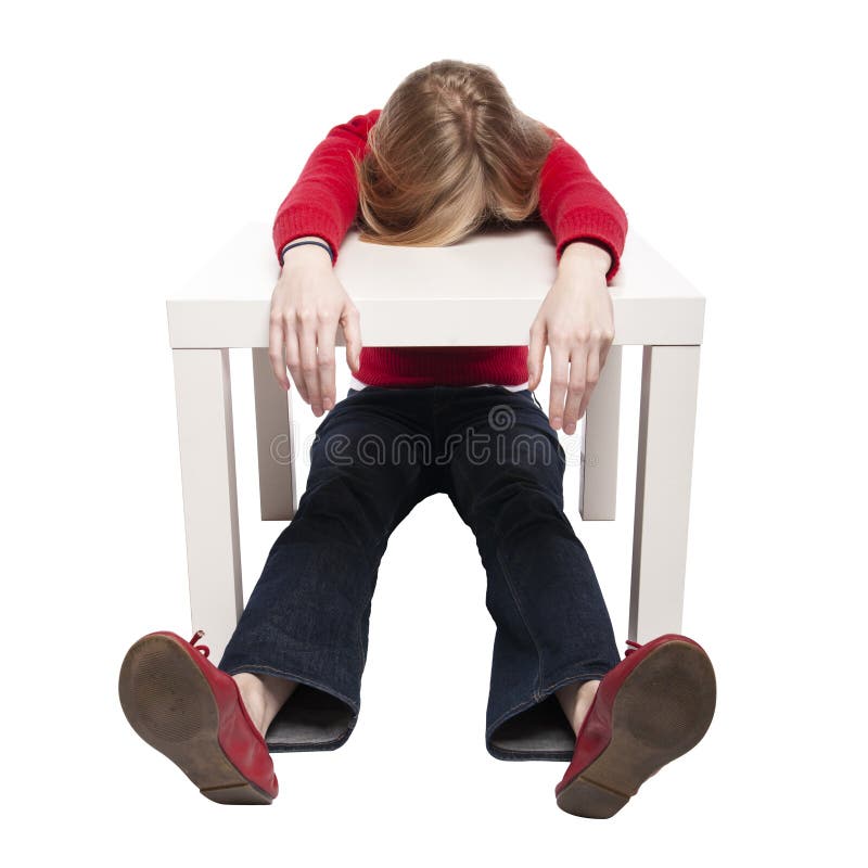 Young woman sleeping at funny small desk