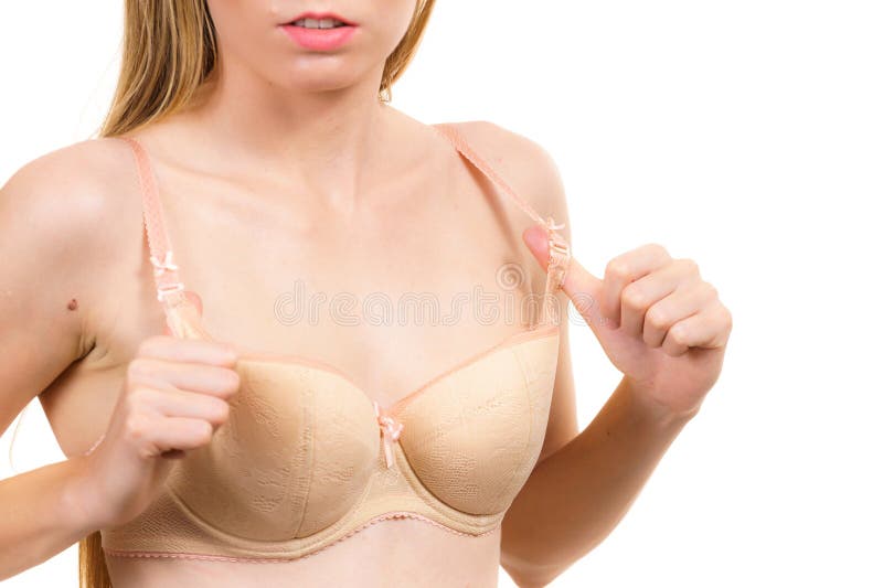 Woman small boobs puts big fruit in her bra Stock Photo