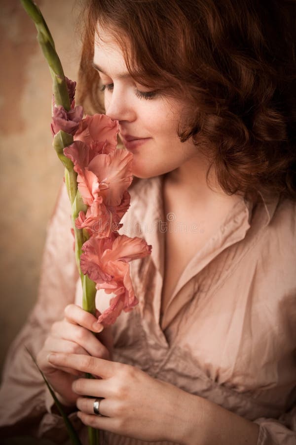 Young woman smells flowers