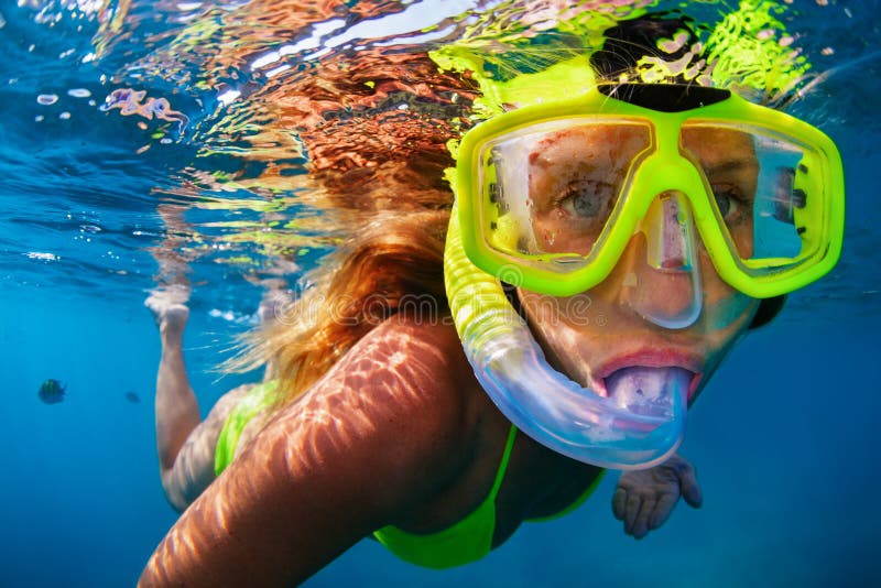 Young woman snorkeling with coral reef fishes stock photography Young woman snorkeling with coral reef fishes stock photography