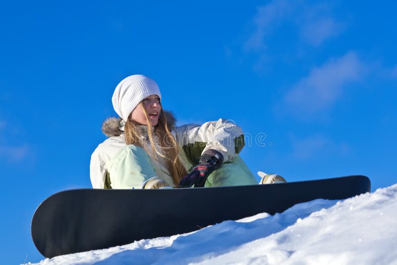 Young woman with snowboard on a slope