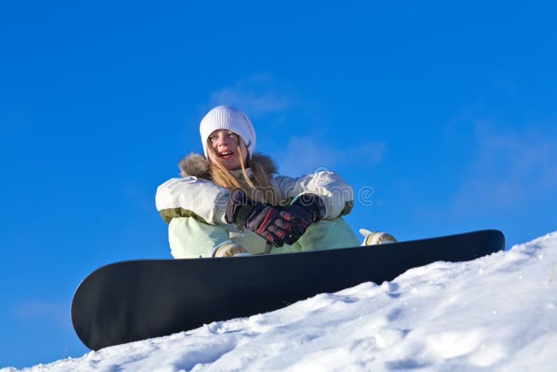 Young woman with snowboard on a slope