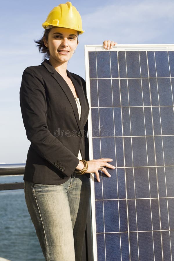 Young woman with a solar panel