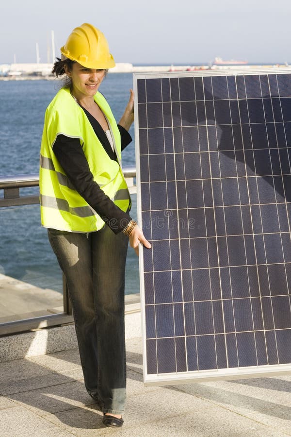 Young woman with a solar panel