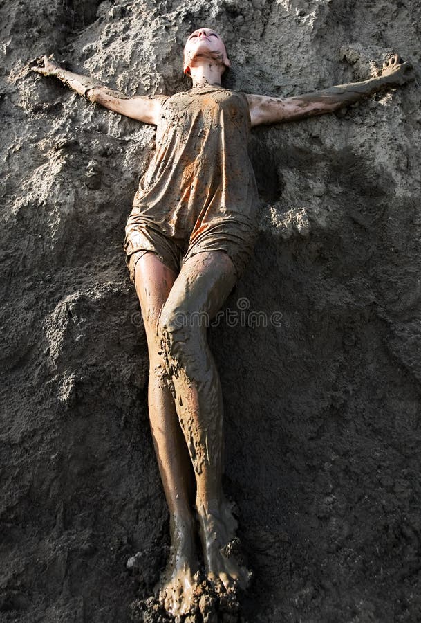 Young woman standing in the mud