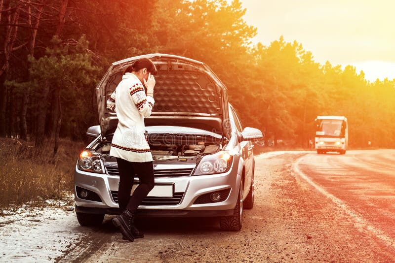 Young woman standing near the broken car. The girl opened the hood and look at the engine. Refit woman car