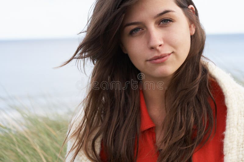 Young Woman Standing In Sand Dunes