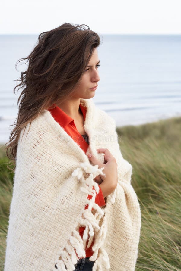 Young Woman Standing In Sand Dunes