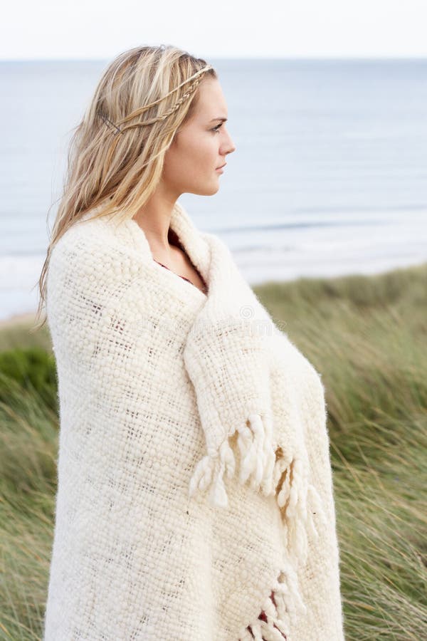 Young Woman Standing In Sand Dunes