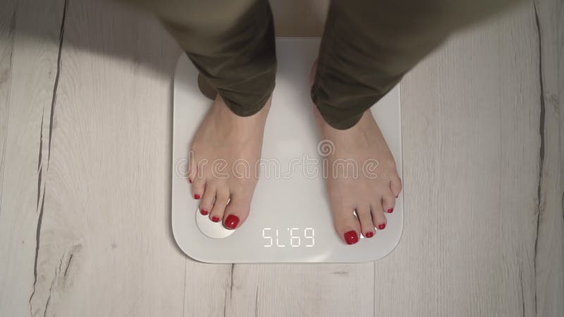 https://thumbs.dreamstime.com/b/young-woman-stands-white-electronic-scale-girl-controls-loses-weight-goes-sports-diet-feet-red-pedicure-240760502.jpg