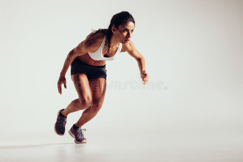 Young woman starting to run and accelerating