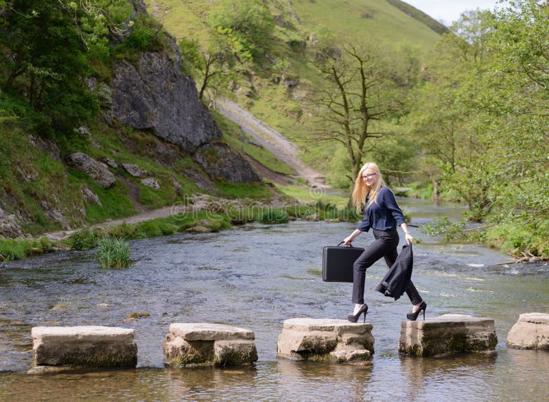 Young woman stepping stones to success metaphor