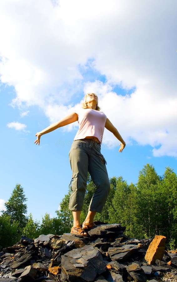 Young woman on a stony hill 2 royalty free stock images