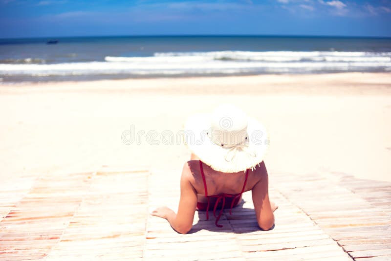 Young Woman in Straw Hat Lying on a Tropical Beach. Blue Sea in Stock ...