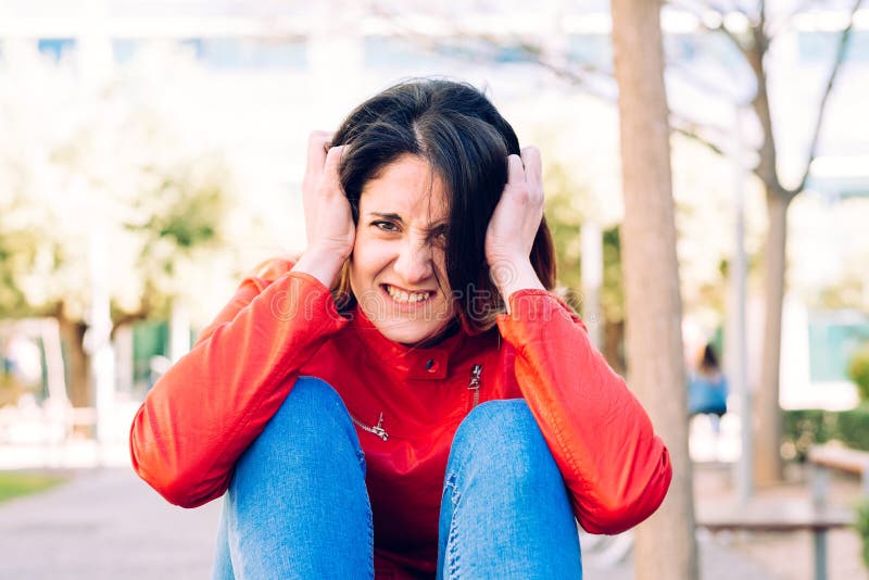 Young woman stressed and anxious with her hands in her hair and crazy face stock photos Young woman stressed and anxious with her hands in her hair and crazy face stock photos
