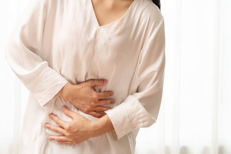 Young woman suffering from abdominal pain feeling stomachache, symptom of pms on white background royalty free stock photo Young woman suffering from abdominal pain feeling stomachache, symptom of pms on white background royalty free stock photo