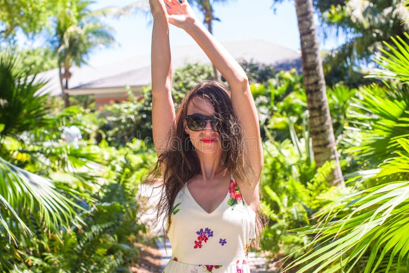 Young woman on summer vacation at lush garden