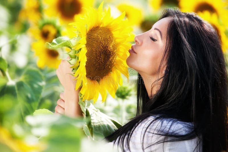 Young woman in sunflower field