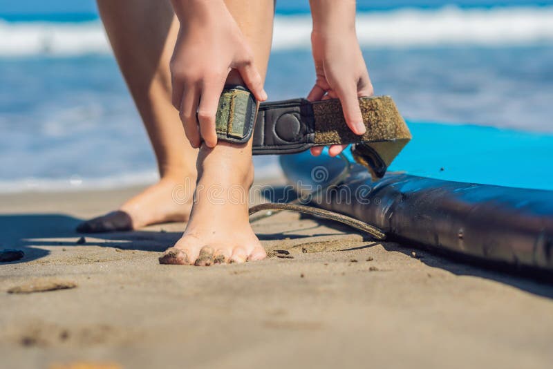Young Woman Surfer Getting on the Surfboard`s Leash Stock Photo Image