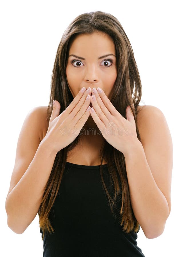 Photo of a beautiful woman with her hands over her mouth and eyes wide from shock. Photo of a beautiful woman with her hands over her mouth and eyes wide from shock.