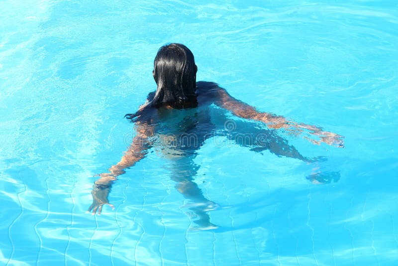 Young woman swimming in pool royalty free stock photo Young woman swimming in pool royalty free stock photo