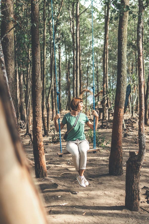 Young woman on the swing in the forest. Bali island. stock photos Young woman on the swing in the forest. Bali island. stock photos