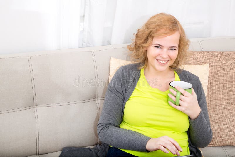 Young woman with a Tablet PC on the Sofa stock photos Young woman with a Tablet PC on the Sofa stock photos