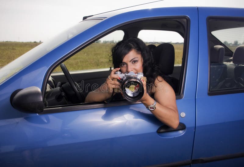 Young woman taking photos with telephoto lens