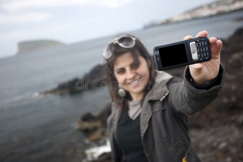 Young woman taking self portrait with mobile phone