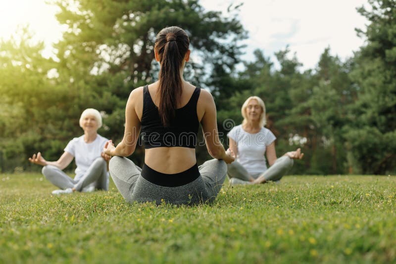 Young woman teaching elderly people yoga royalty free stock photo Young woman teaching elderly people yoga royalty free stock photo