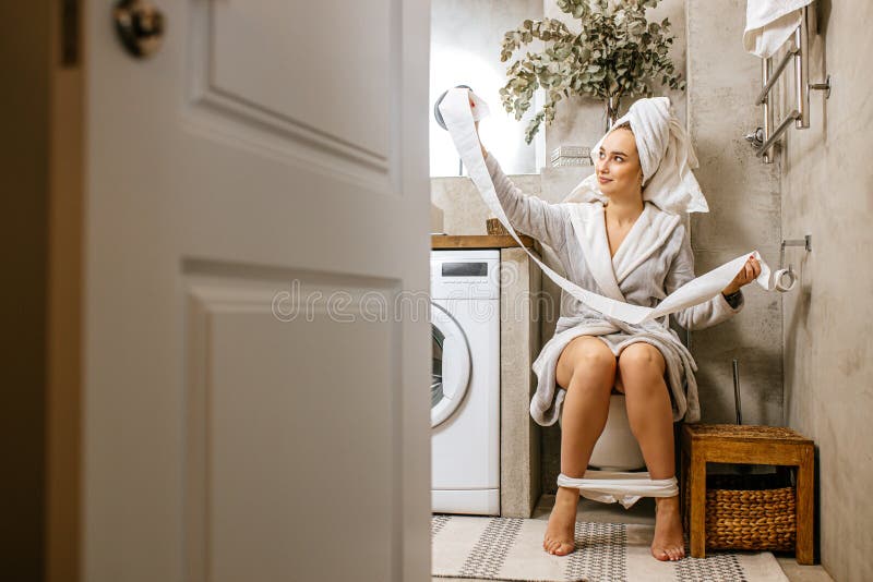 Young chick with pretty butt pissing in the toilet