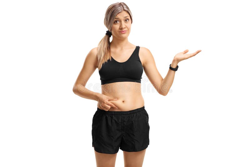 Young woman touching her belly fat and gesturing with hand stock photo Young woman touching her belly fat and gesturing with hand stock photo
