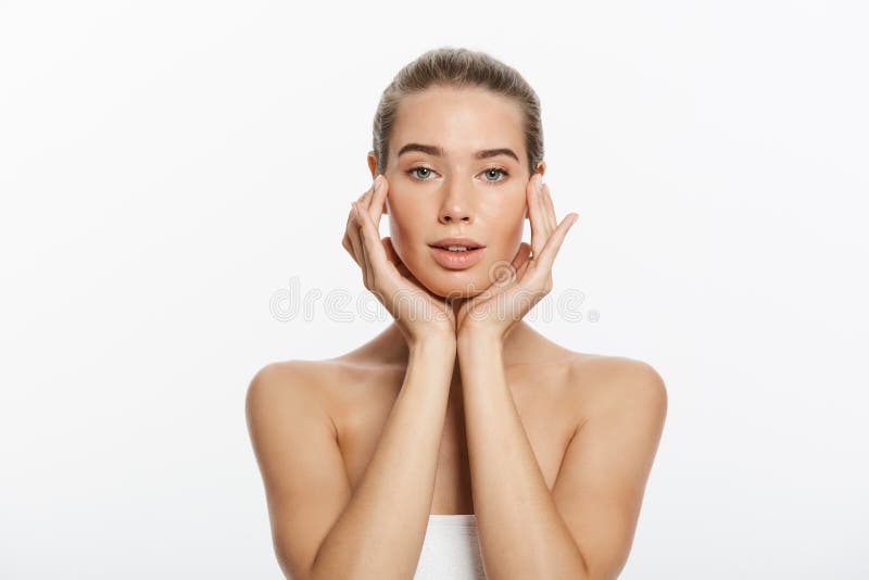 Young woman touching her face isolated on white background stock photos Young woman touching her face isolated on white background stock photos