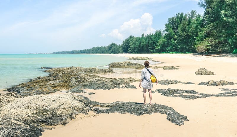 Young woman traveler enjoying sunny day at tropical beach stock images Young woman traveler enjoying sunny day at tropical beach stock images