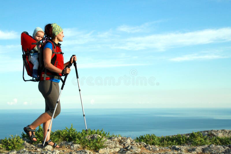 A young woman trekking with her baby