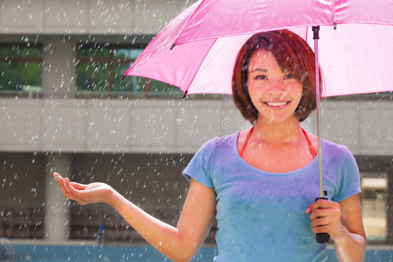 Young woman under pink umbrella stock photo