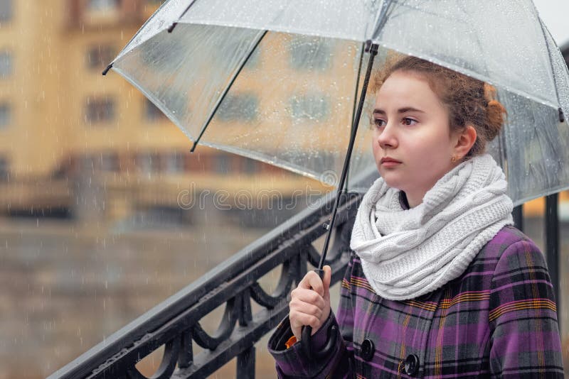 sad girl in the rain with umbrella