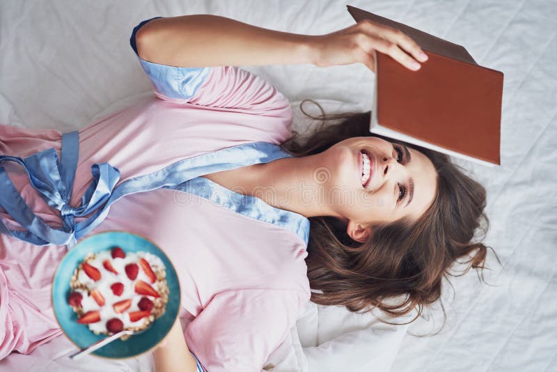 Portrait of young woman in underwear eating cereals