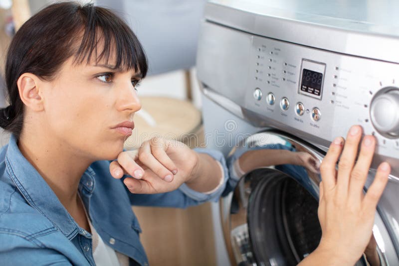 young woman upset with washing machine