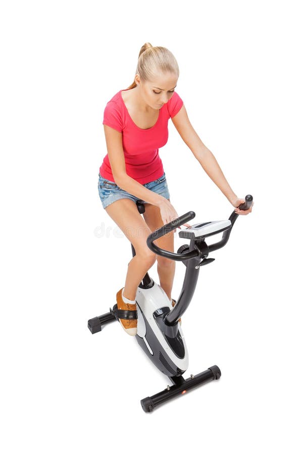Young Woman Uses Stationary Bicycle Trainer. Stock Image Image of
