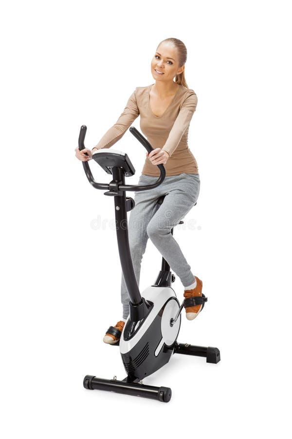 Young Woman Uses Stationary Bicycle Trainer. Stock Photo Image of