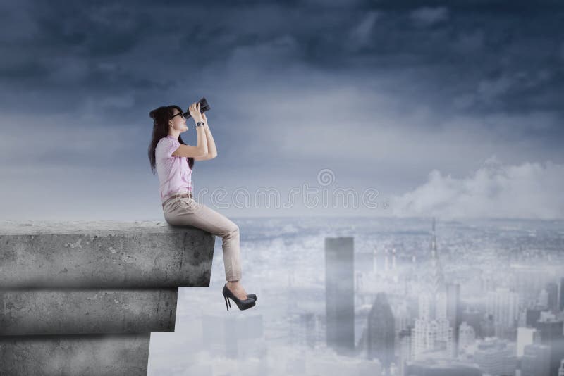 Young woman using binoculars on rooftop royalty free stock image Young woman using binoculars on rooftop royalty free stock image