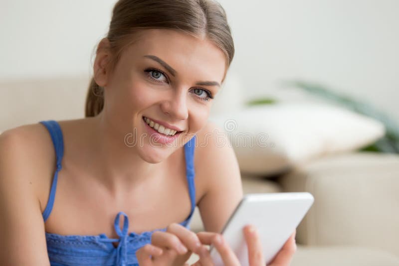 Young woman using digital tablet at home, headshot portrait.