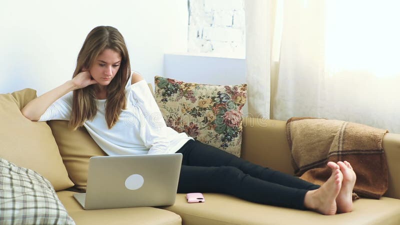 Young woman using laptop on the sofa