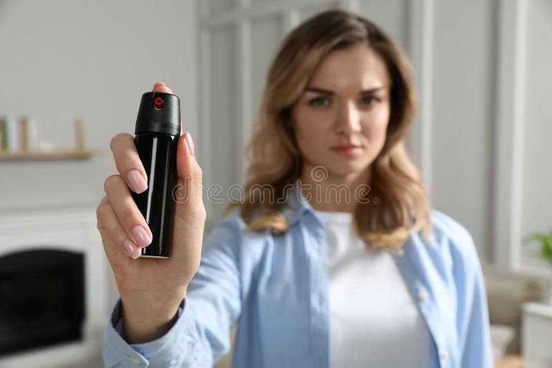 Young Woman Using Pepper Spray at Home, Focus on Hand Stock Photo Image of robber, girl 247941130